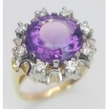 A Gorgeous 14K Yellow Gold Amethyst and Diamond Ring. Central round cut 5ct amethyst with a