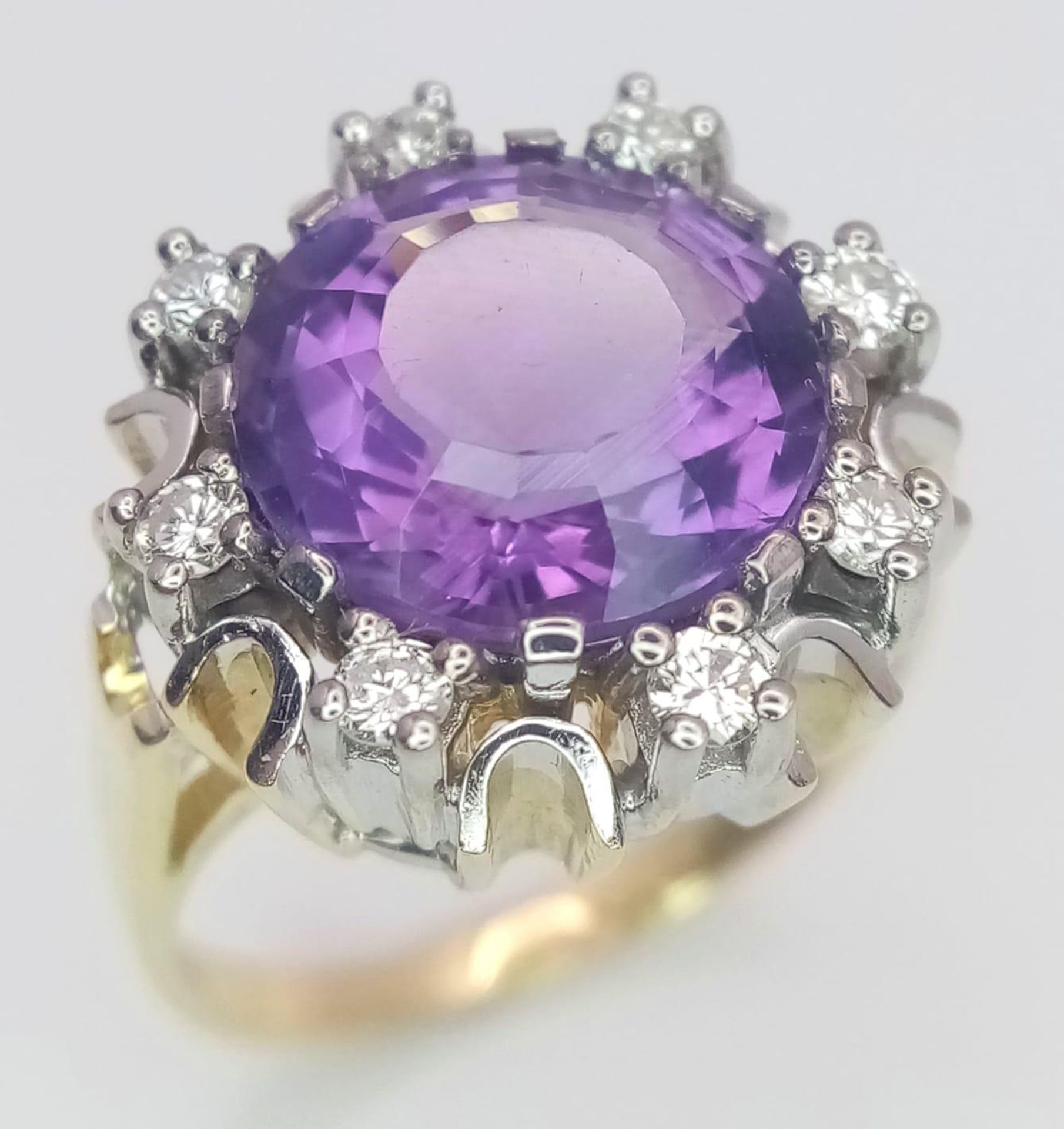 A Gorgeous 14K Yellow Gold Amethyst and Diamond Ring. Central round cut 5ct amethyst with a