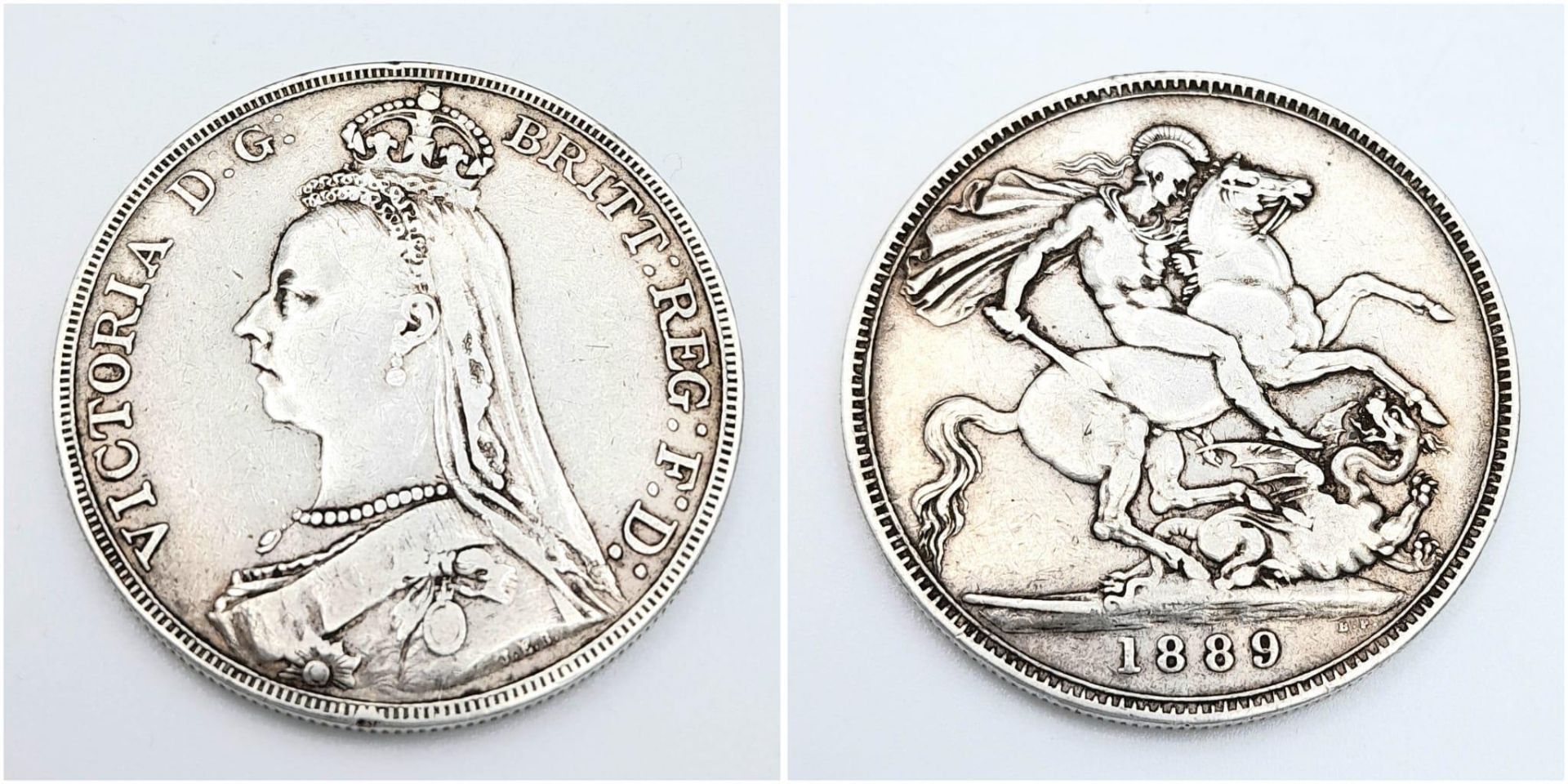 An 1889 Queen Victoria Silver Crown Coin. VF+ grade but please see photos for conditions.