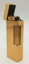 A vintage, gold plated DUNHILL lighter, hight: 6. 4 cm, weight: 76 g.