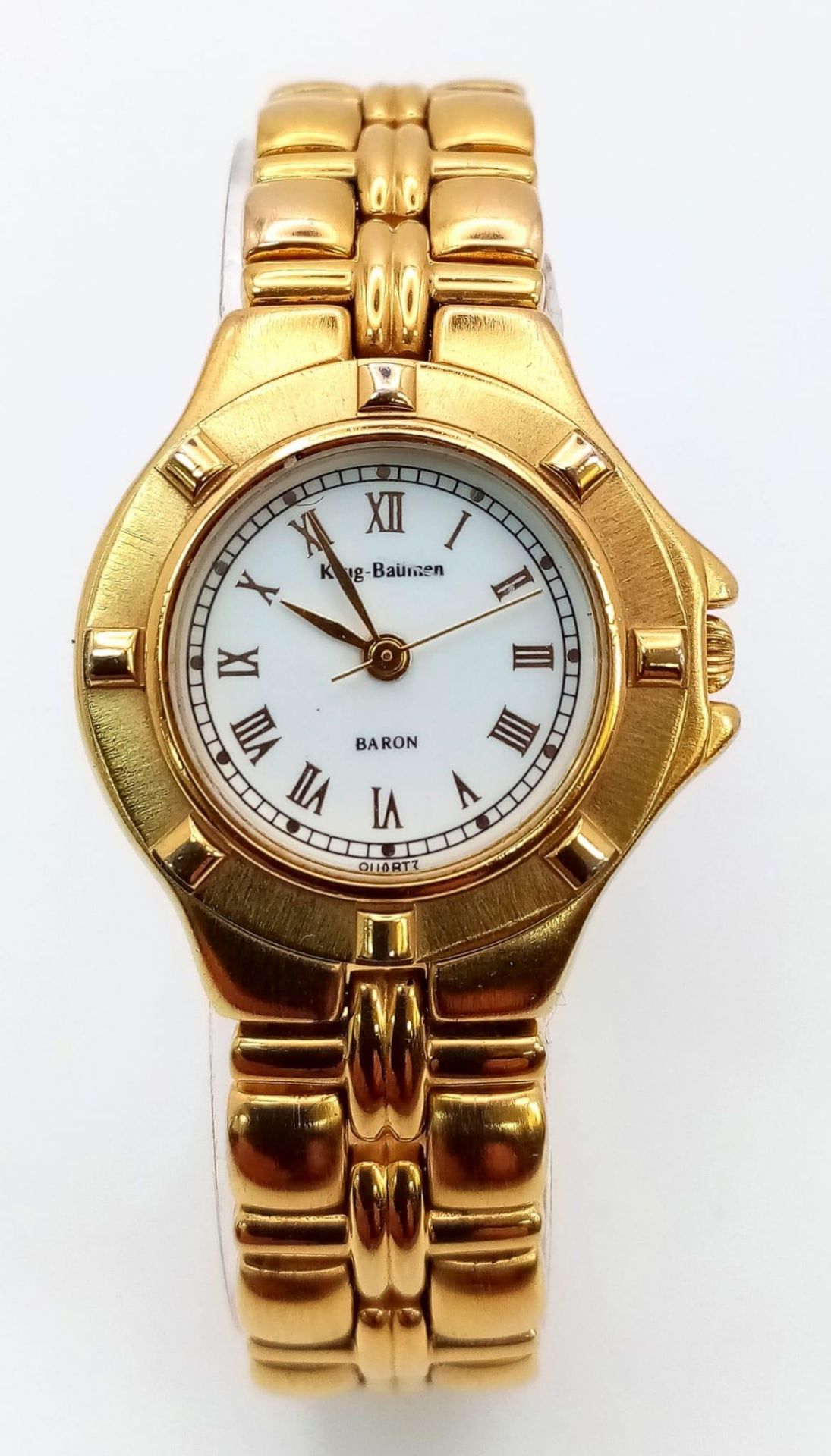 A Krug Baumen Gold Plated Quartz Ladies Watch. Stainless steel bracelet and case - 27mm. White dial.