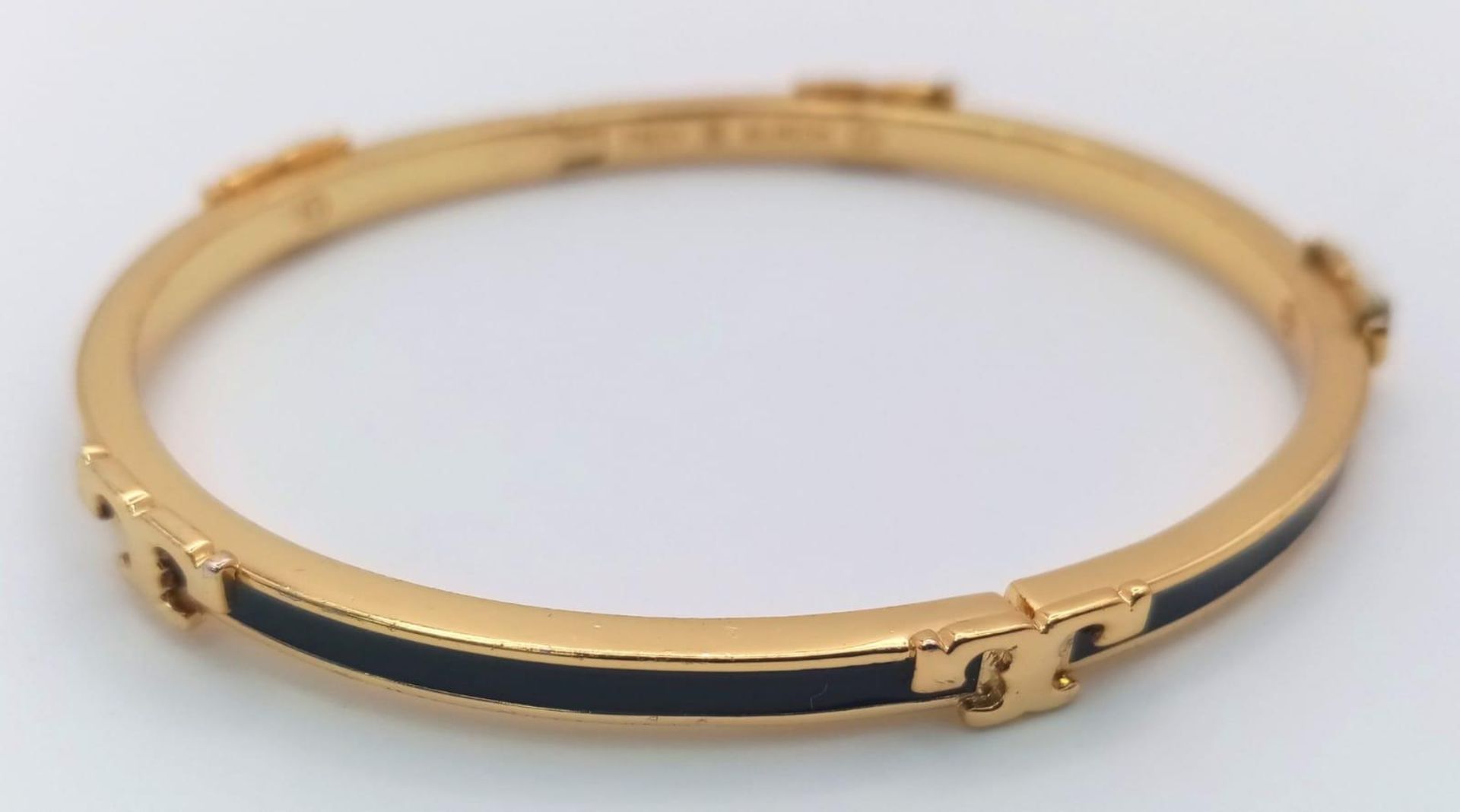 A gold plated, TROY BURCH design, black enamelled bangle. Clasp not tight. Inner dimensions: 59 x 50 - Image 3 of 4