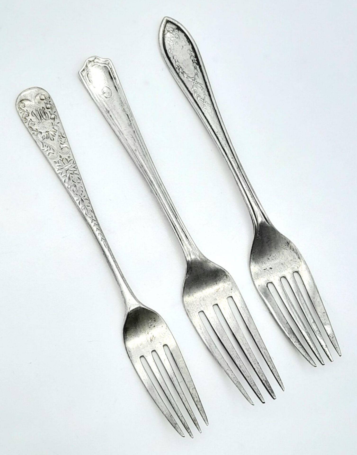 An antique eclectic collection of sterling silver forks with different designs. Come with full
