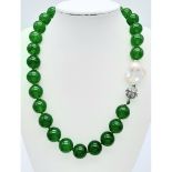 A Green Jade and Keisha Baroque Pearl Necklace. 14mm green jade beads with a baroque pearl