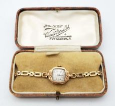 An Antique 9K Gold Ladies Mechanical Watch. 9K gold bracelet and case - 17mm. White patinaed dial.