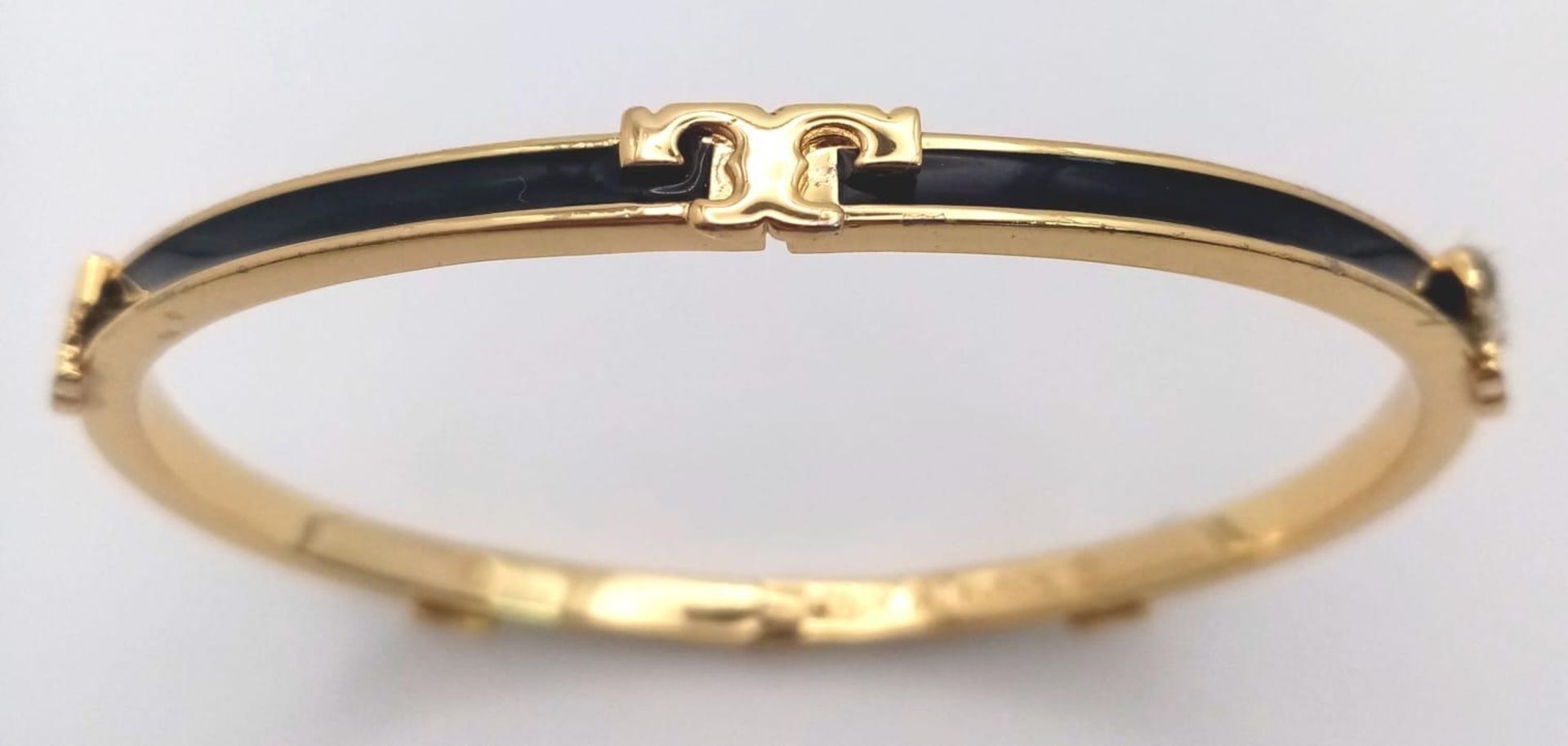 A gold plated, TROY BURCH design, black enamelled bangle. Clasp not tight. Inner dimensions: 59 x 50 - Image 2 of 4