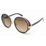 A Jimmy Choo ladies sunglasses in original snake skin case.