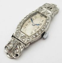 A FABULOUS ART DECO PLATINUM AND DIAMOND WATCH(OVERWOUND) .