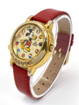 A Lorus Quartz Mickey Mouse Watch. Red leather strap. Gilded case - 34mm. Mickey dial. In working