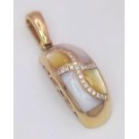 A 14 K yellow gold pendant with yellow and white Mother of pearl and diamonds arranged in a curvy