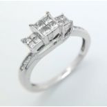 A 10 K white gold diamond ring with a cross over, step design. Size: N, weight: 3.2 g. Good
