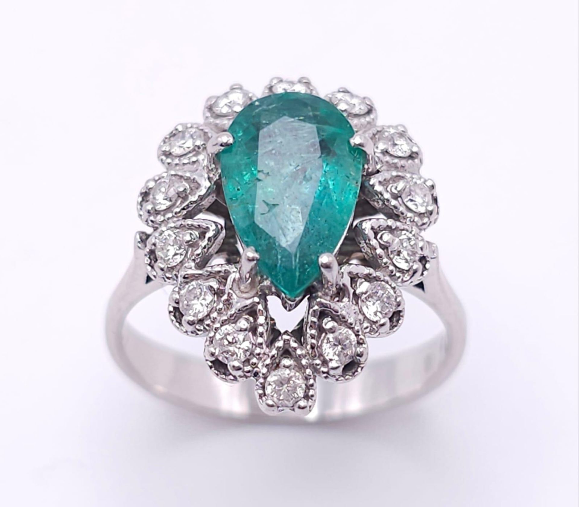 An 18K White Gold Diamond and Emerald Ring. 1ct central teardrop emerald with a 1ctw brilliant round - Image 2 of 7