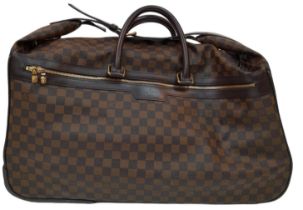 A Louis Vuitton Damier Ebene Eole Convertible Travel Bag. Leather exterior with gold-toned hardware,