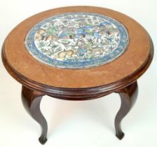 AN ANTIQUE SMALL QAJAR TABLE WITH CERAMIC TOP DEPICTING THE PERSIAN VICTORIES IN BATTLE . 51cms TALL