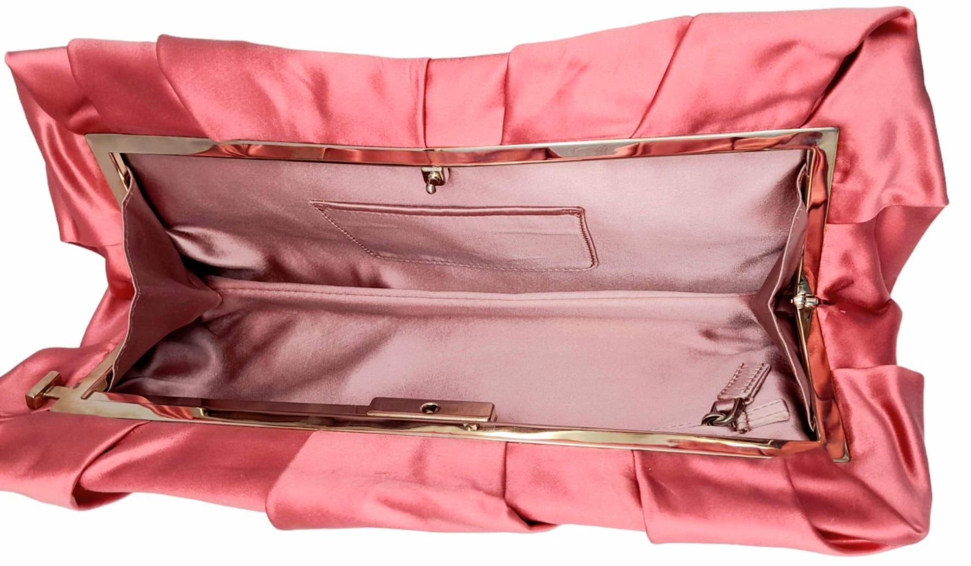 A Prada Pink Pleated Clutch Bag. Satin exterior with silver-toned hardware and press lock closure to - Image 6 of 9