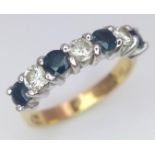 An 18 K yellow gold ring with a band of alternating round cut diamonds and blue sapphires. Size: