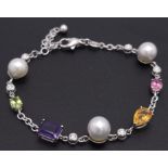 An 18 K white gold chain bracelet with a variety of gemstones (peridot, amethyst, citrine, etc)