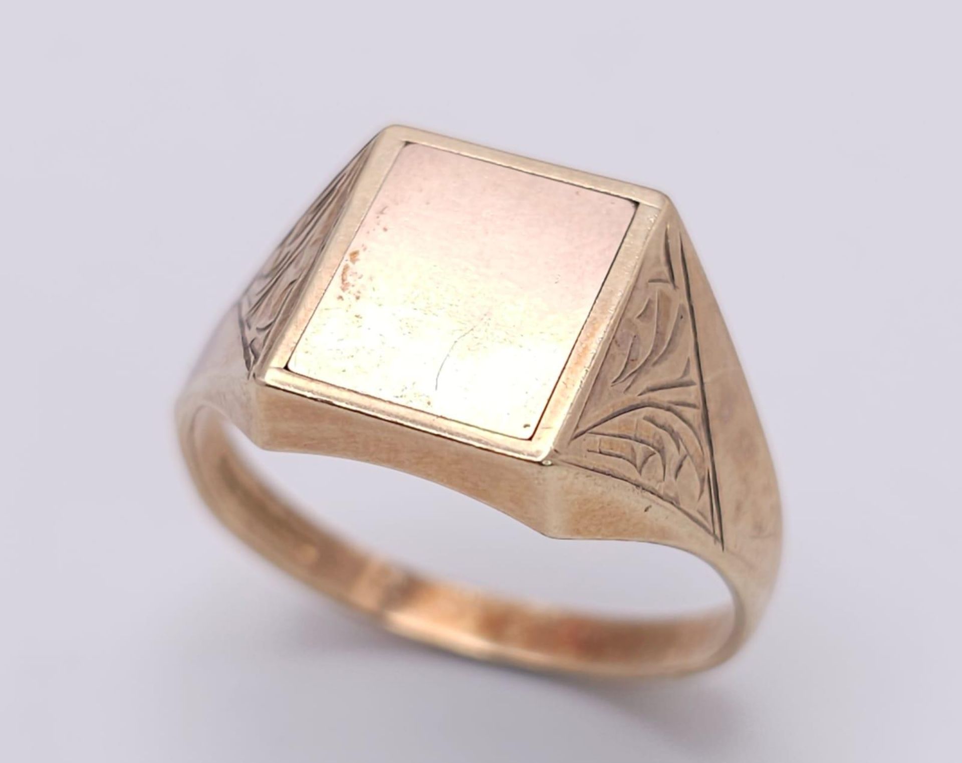A GENTS 9K GOLD SIGNET RING WITH A HIDDEN MASONIC SYMBOL ON THE REVERSE, ENGRAVED PATTERN