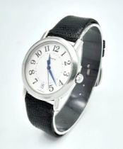 A Coach Quartz Gents Watch. Black leather strap. Stainless steel case. White dial. In working order.