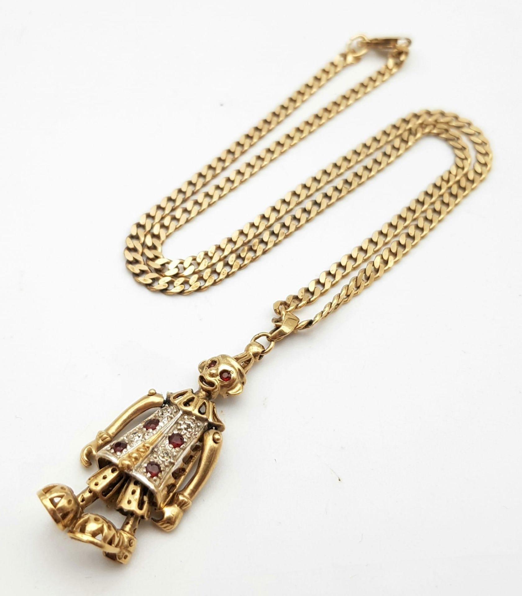 A 9K GOLD ARTICULATED MONKEY CLOWN WITH RUBY AND DIAMOND BODY ON A 42cms INTERLINK NECK CHAIN . 12.