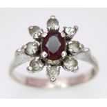 A fancy 925 silver Zirconia and Garnet floral cluster ring. Total weight 2.5G. Size K.