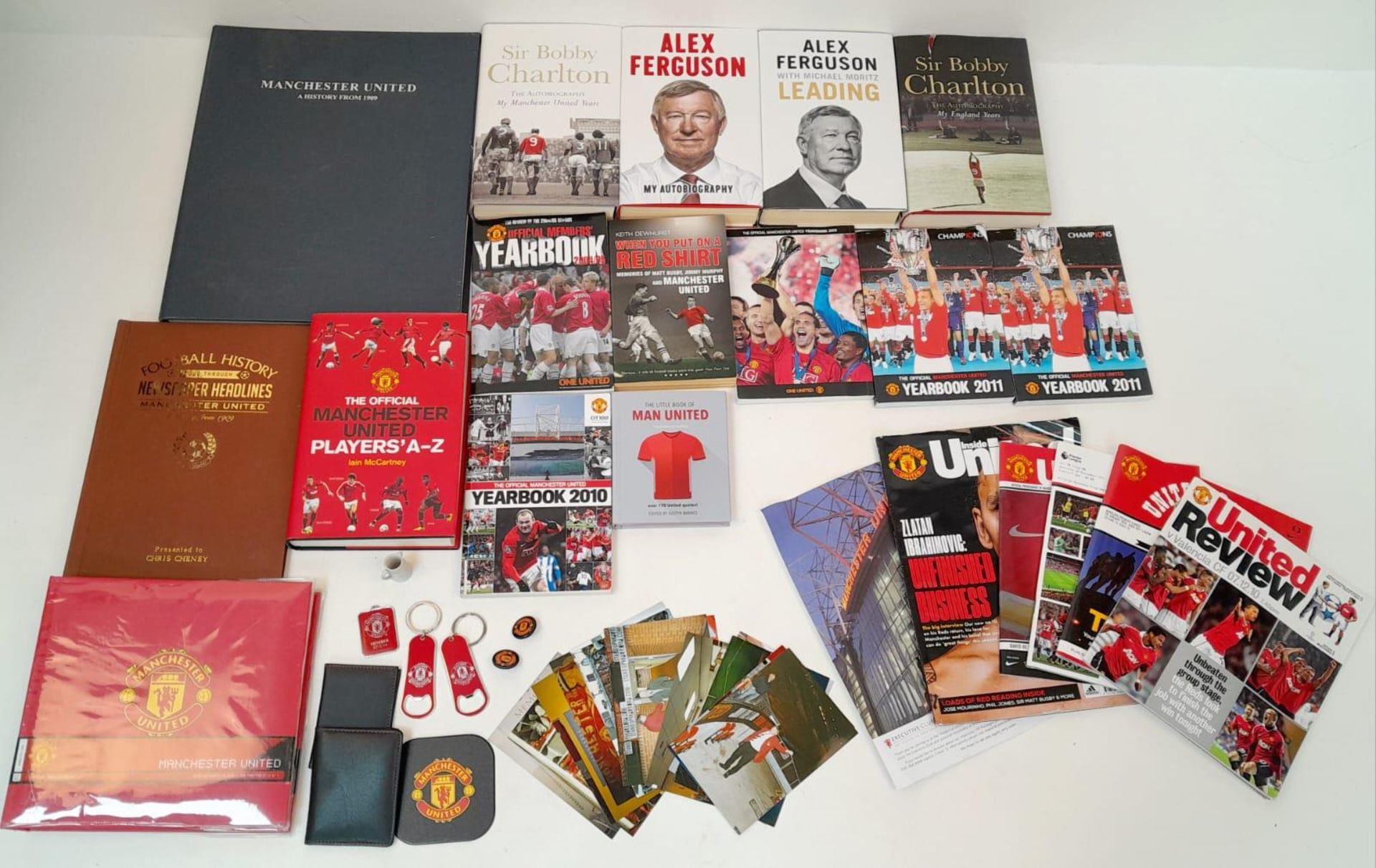 A Potpourri of Manchester United Collectibles: Books, Pictures and Programmes. Over thirty items.