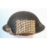 WW2 British MK II Helmet with Cam Net and 1944 Dated (D-Day) Field Dressing.