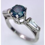 A BEAUTIFUL VINTAGE PLATINUM RING WITH 1ct SAPPHIRE CENTRE STONE AND TAPERED DIAMOND SHOULDERS . 4.