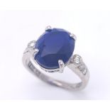 An 18K White Gold Sapphire and Diamond Ring. Central 3ct sapphire with diamond accents. Size M. 4.
