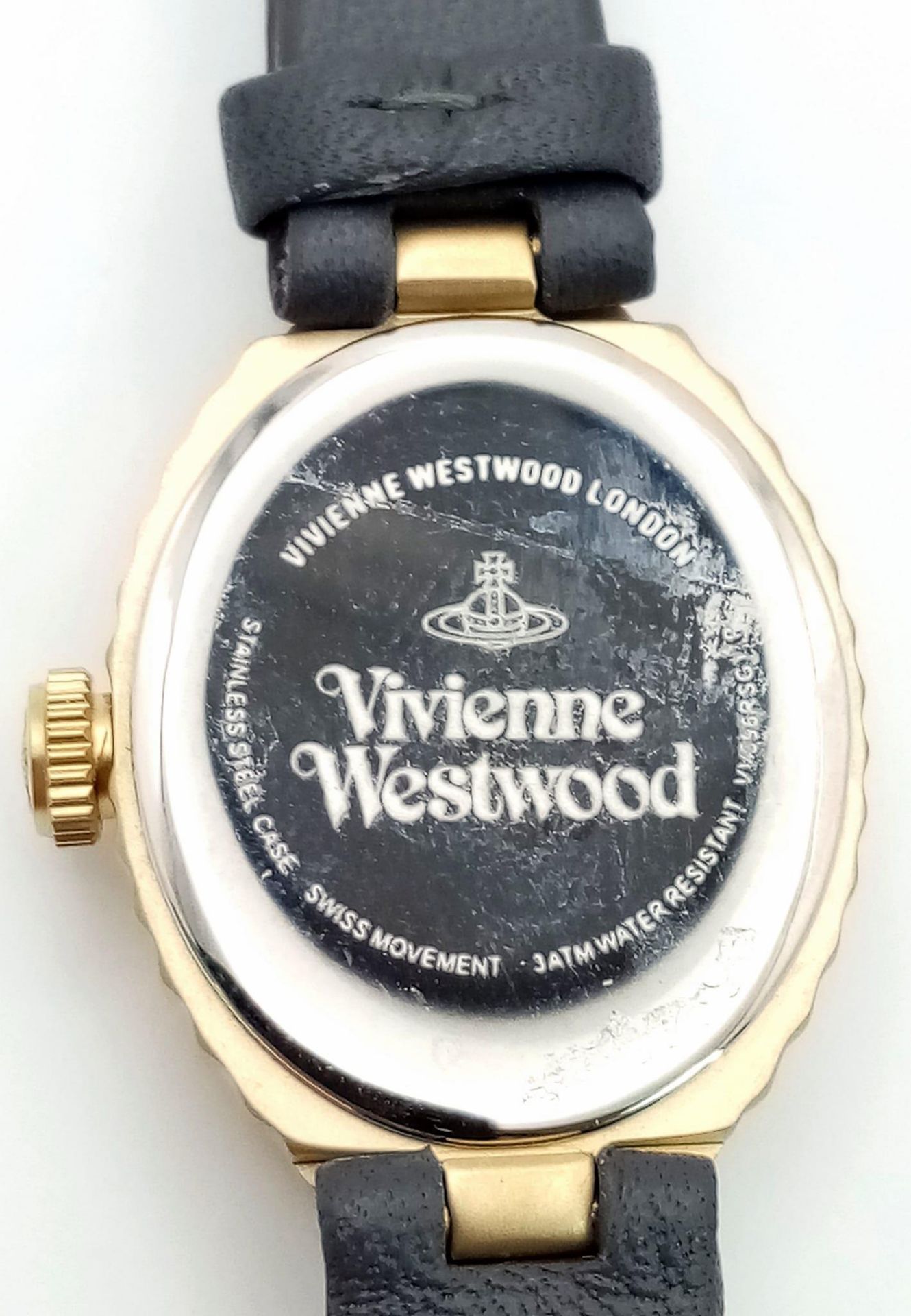 A Vivienne Westwood Oval Shell Watch. Grey leather strap. Gilded ceramic case - 21mm. Pink dial. - Image 5 of 5