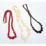 A group of three vintage necklaces: one mother of pearl, one red agate and one black onyx.