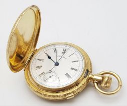 An Antique Waltham 18K Gold Full Hunter Pocket Watch. The case is ornately decorated in a floral