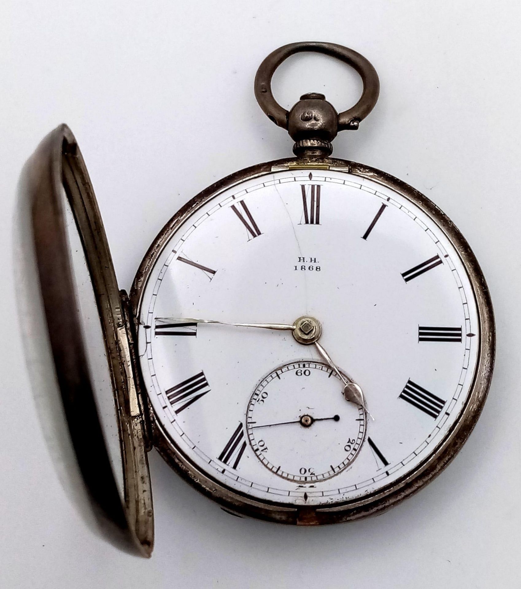 An Antique Sterling Silver Cased H.H. 1868 Pocket Watch. Hallmarks for London 1862. White dial