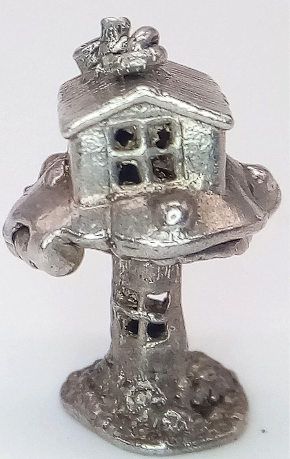 A VINTAGE STERLING SILVER TREE HOUSE CHARM, WHICH OPENS TO REVEAL A WIZARD INSIDE, WEIGHT 4G