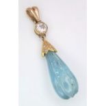 A CARVED TEAR DROP AQUAMARINE AND DIAMOND PENDANT SET IN HIGH CARAT GOLD . 1.9gms