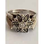 Impressive 18 carat WHITE GOLD and DIAMOND RING. Having seven DIAMONDS mounted to top in floral