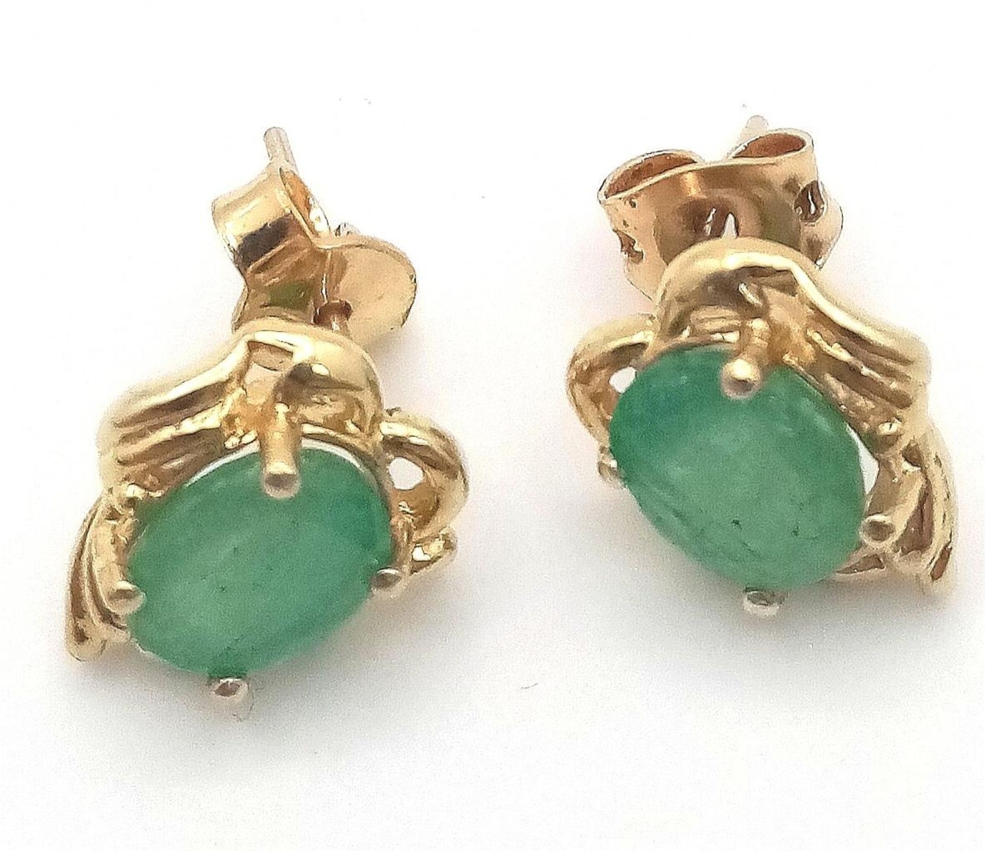 A Pair of Oval Cut 14K Gold Emerald Earrings. 2ctw. 3.3g total weight.