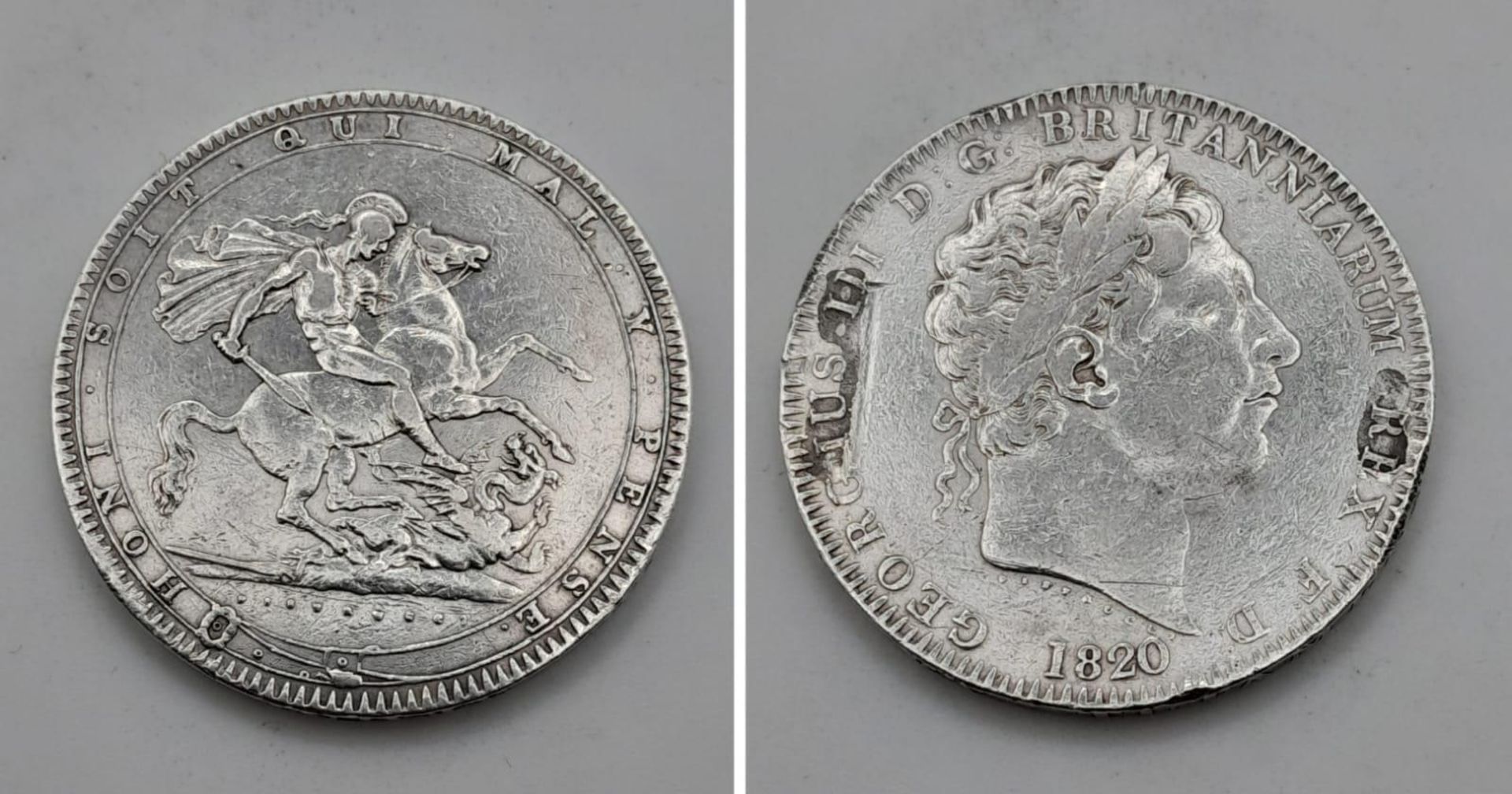An 1820 George III Silver Crown Coin. Strong VF grade but a couple of small abrasions on obverse -