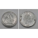 An 1820 George III Silver Crown Coin. Strong VF grade but a couple of small abrasions on obverse -