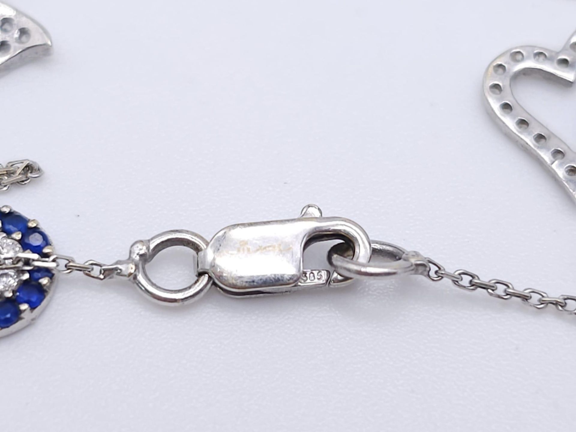 A 14kt White Gold Diamond Set Charm Bracelet. Variety of charms, this bracelet measures 16cm in - Image 4 of 5