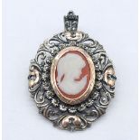 An Antique Silver and Rose Gold Decorative Cameo Brooch. Central small cameo with a rose gold halo