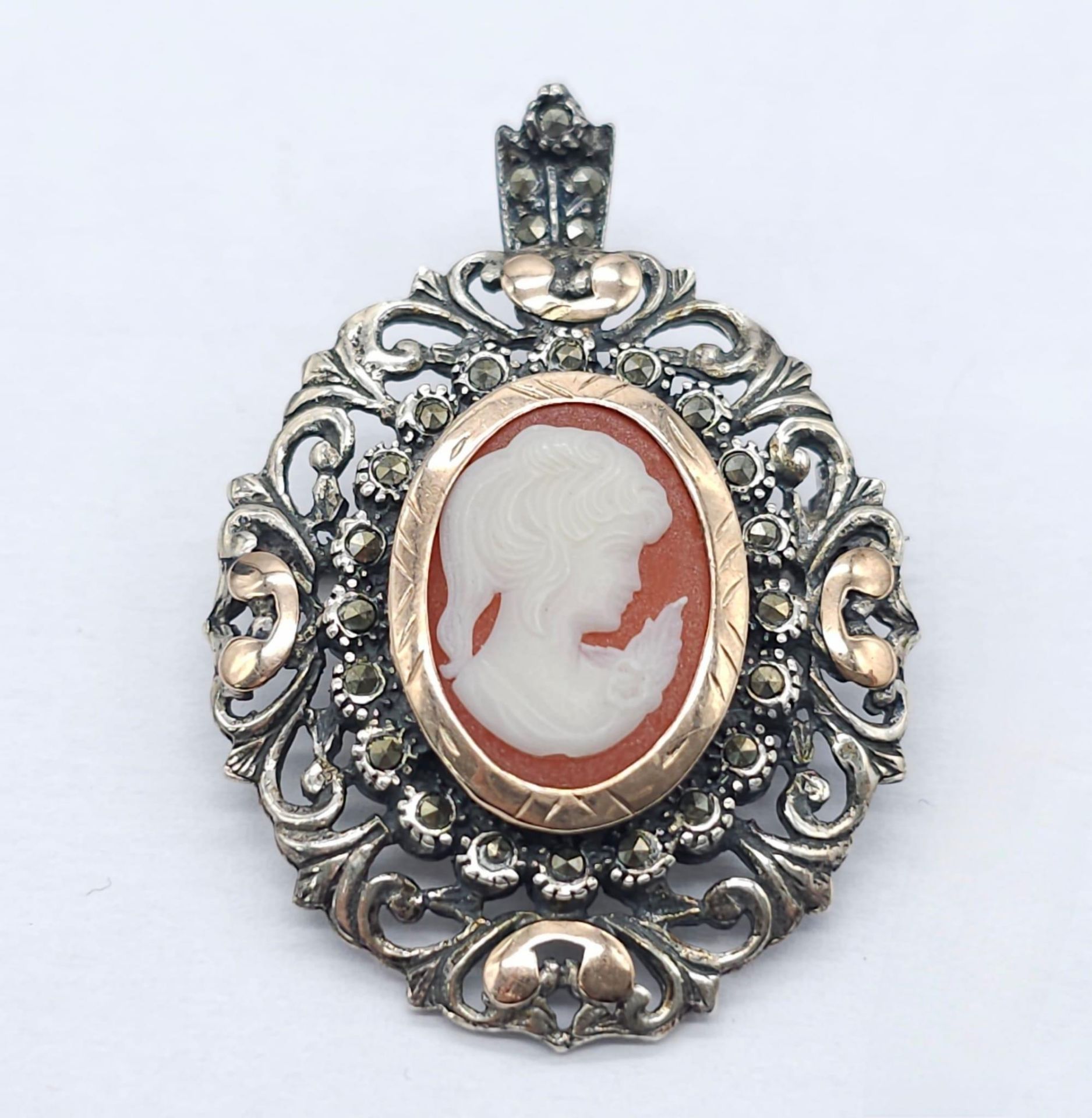 An Antique Silver and Rose Gold Decorative Cameo Brooch. Central small cameo with a rose gold halo