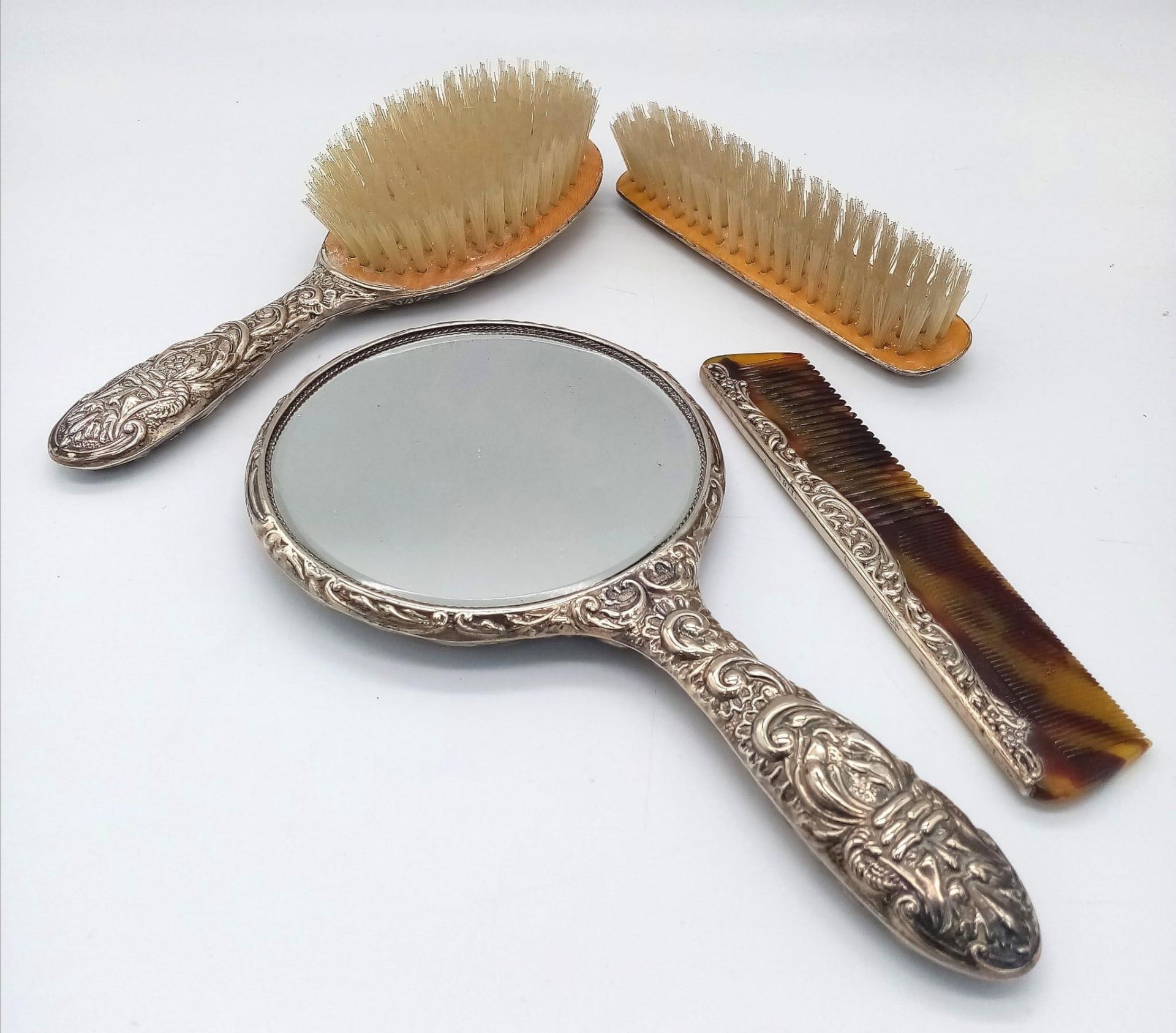 A vintage vanity set consisting of a hair brush, a clothes brush, a comb and a vanity mirror. - Image 2 of 3