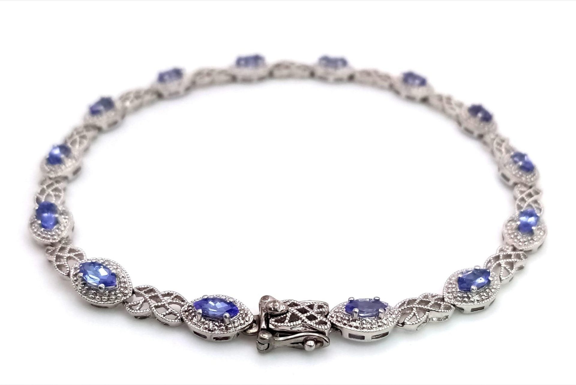 A 9K White Gold, Purple Sapphire and Diamond Tennis Bracelet. Eye-shaped links with sapphire - Image 3 of 5