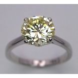 An 18K White Gold and 2.47ct VVS Yellow Diamond Ring. A brilliant round cut dancing centrepiece -