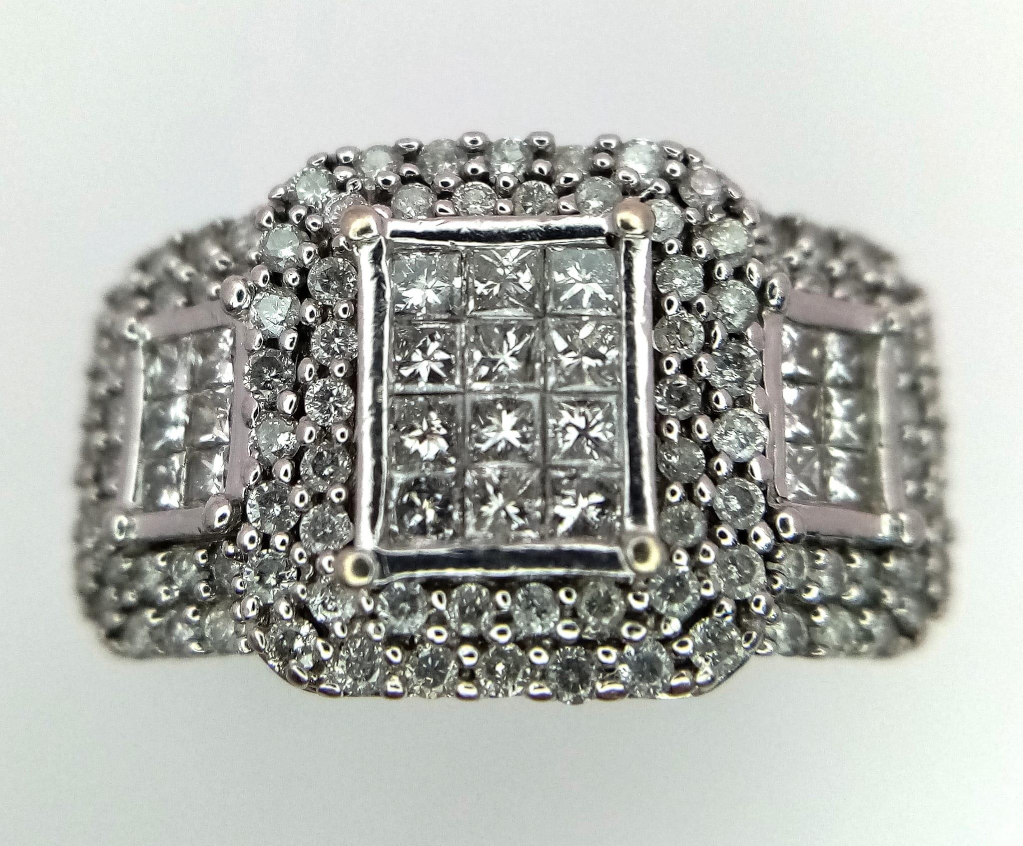 An Art Deco Style 18K White Gold and Diamond Ring. A belt-buckle design of round and princess cut