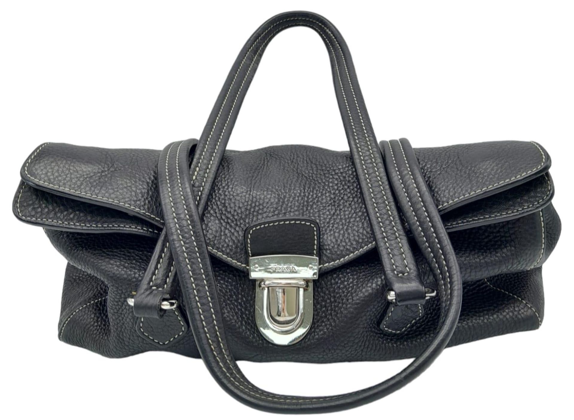 A Prada Black Vitello Shoulder Bag. Leather exterior with silver-toned hardware, two straps, push