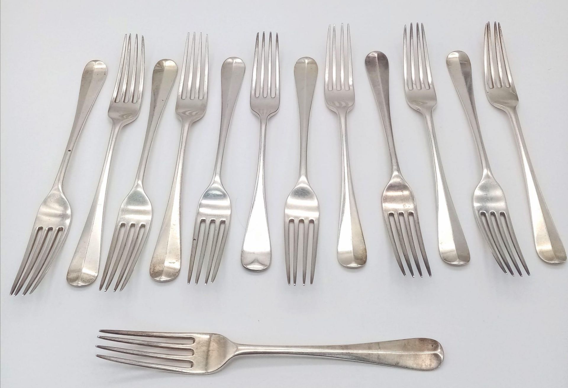 Thirteen Antique Sterling Silver Dining Forks. 20cm. 980g weight. Hallmarks for London 1924