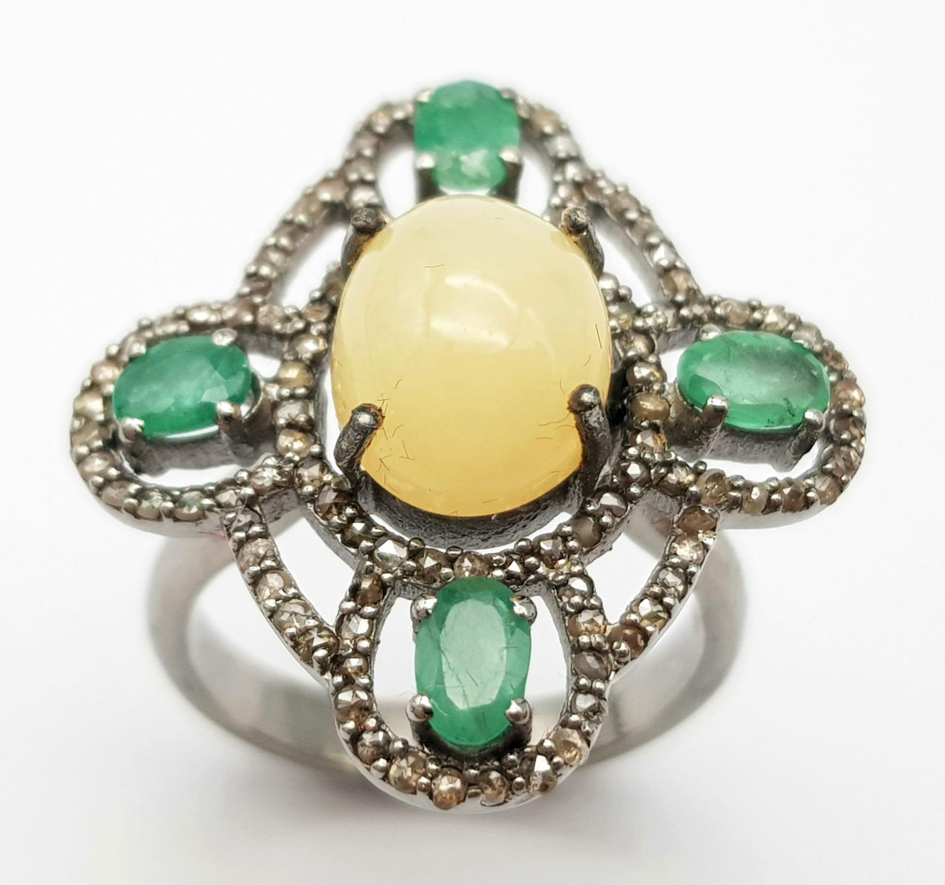 A Beautifully Designed 2.25ct Opal Ring with 0.90ctw of Emeralds and 0.85ctw of Diamond Accents. - Image 2 of 6