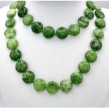 A Green and White Jade Coin Bead Necklace. 14mm beads. 68cm length.